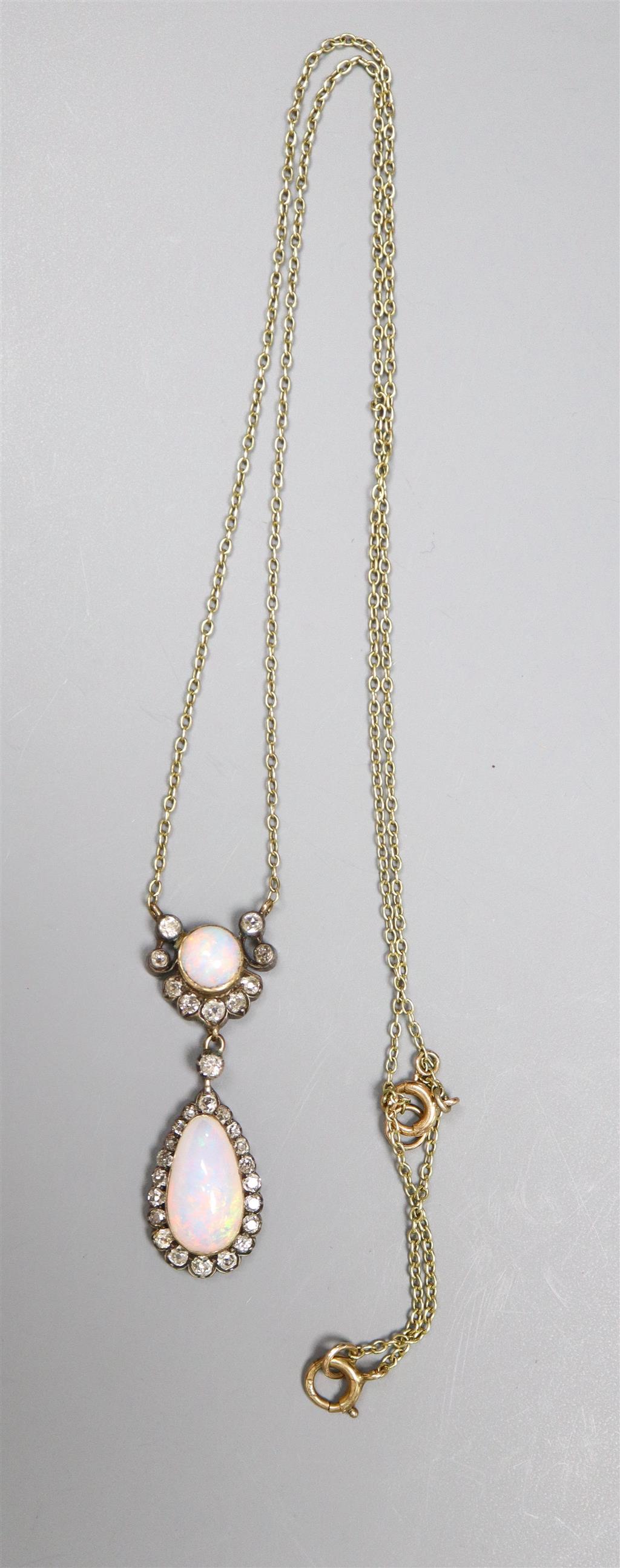 An Edwardian yellow and white metal, two stone white opal and diamond cluster set drop pendant necklace,